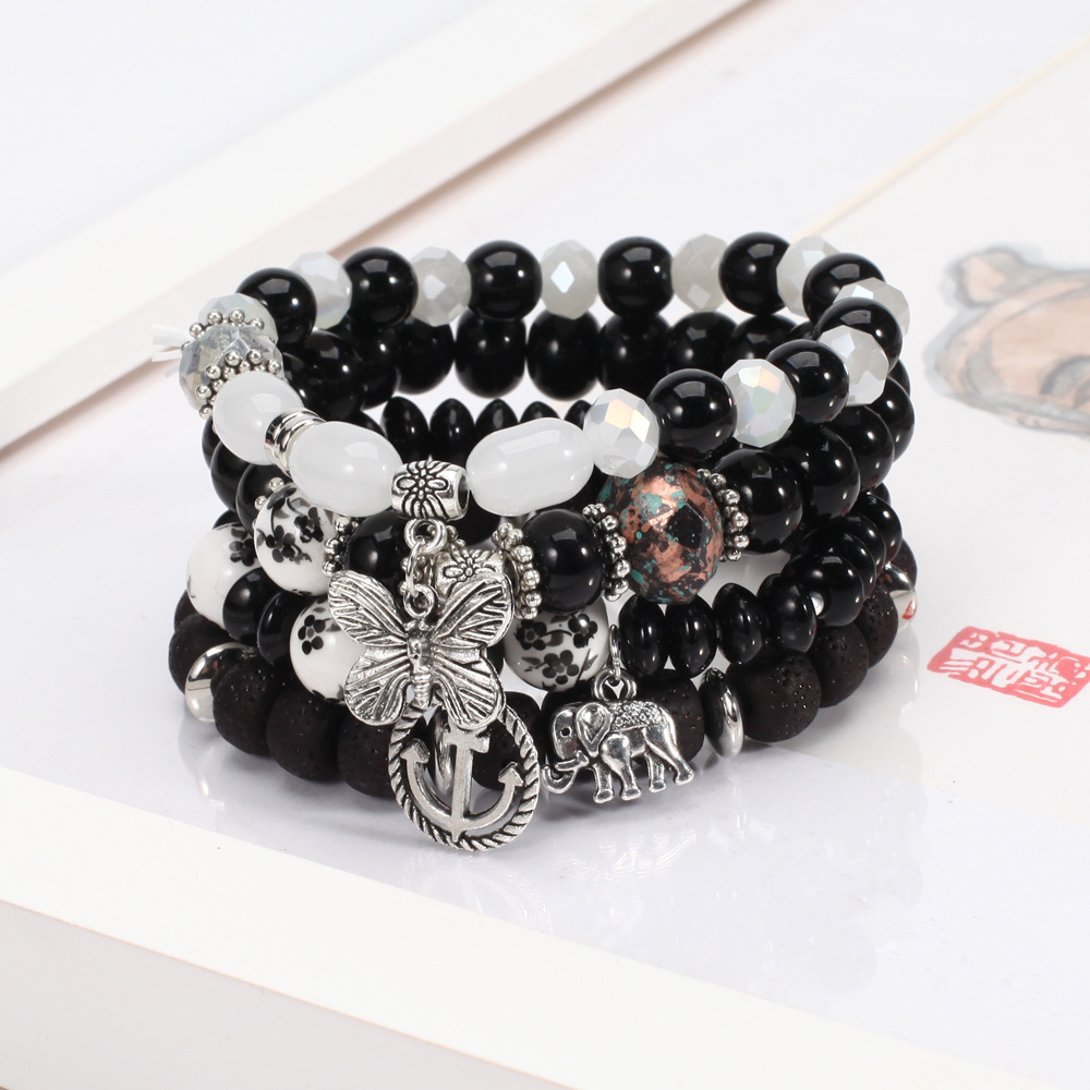 4 layered black beaded bracelet with charms